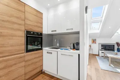 a kitchen with white cabinets and a window at Charmant 2p au port de Nice - Calme et climatisé in Nice