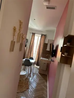 a hallway with a room with a table and a kitchen at MOON 23 - Appartement Nice 2P in Nice