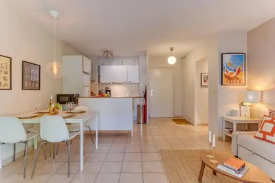 a living room and kitchen with a table and a couch at IMPERIA AP4490 by RIVIERA HOLIDAY HOMES in Nice
