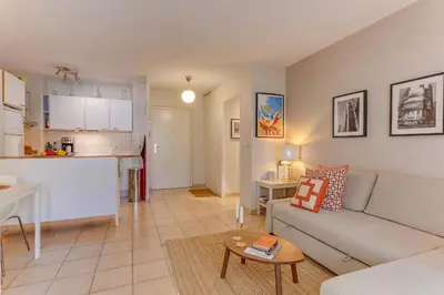a living room and kitchen with a couch and a table at IMPERIA AP4490 by RIVIERA HOLIDAY HOMES in Nice