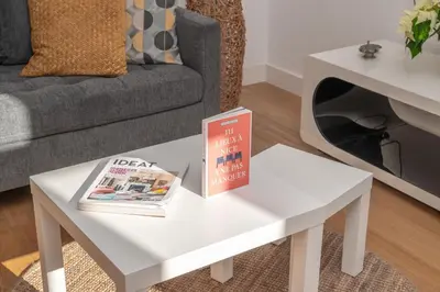 a white coffee table in a living room with a book on it at Quartier Libération - La Vie à la Niçoise in Nice