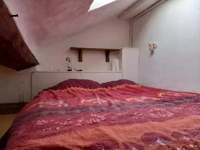 a bedroom with a large bed with a colorful blanket at Nice Plage in Nice