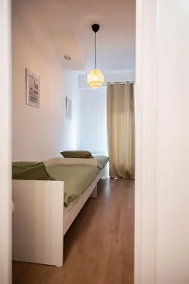a small bedroom with a bed and a window at Appartement-Suite neuf - 2 chambres - 1 min mer in Nice
