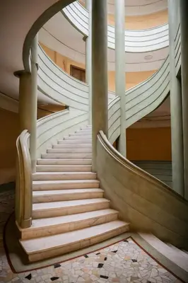 a spiral staircase in a building with white steps at Appartement-Suite neuf - 2 chambres - 1 min mer in Nice