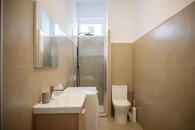 a bathroom with a sink and a toilet and a shower at Appartement-Suite neuf - 2 chambres - 1 min mer in Nice