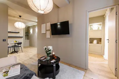 a living room with a couch and a tv on the wall at Wonderful Stay close to Garibaldi - Aircon in Nice