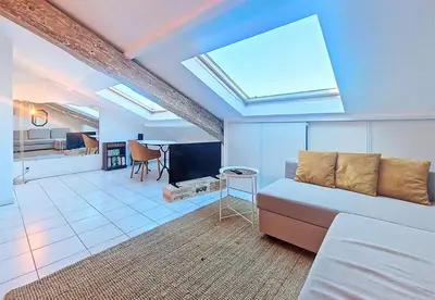 a living room with a couch and a table at Nestor&Jeeves - L ESCURIAL - Central in Nice