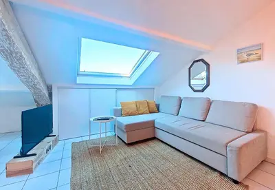 a living room with a couch and a window at Nestor&Jeeves - L ESCURIAL - Central in Nice