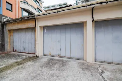 three garage doors on the side of a building at Nice Renting - AMOUR - Haussmann Luxury Sea Balcony Free Parking in Nice