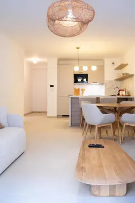 a living room with a table and a kitchen at T3 résidence neuve Centre-Ville 6 Couchages in Nice