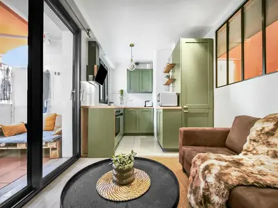 a living room with a couch and a table at Central, élégant & cosy in Nice