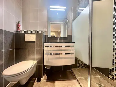a bathroom with a toilet and a sink and a mirror at Studio design et lumineux près du Port de Nice in Nice