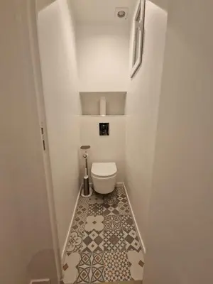 a small bathroom with a toilet and a tile floor at Alex&Chris in Nice