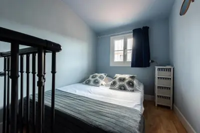 a small bedroom with a bed and a window at La Suite Londres in Nice