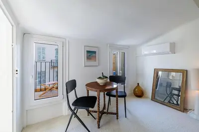 a room with a table and chairs and a window at Charming Ultra Central 1 Bdr in Nice