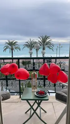 a table and chairs on a balcony with a view of the ocean at Casa Giacometti Vue Mer Lumiere et Horizon in Nice