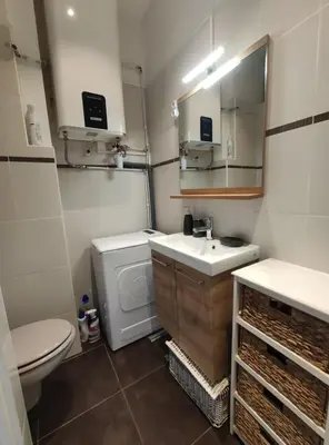 a bathroom with a sink and a toilet and a mirror at Beautiful studio apartment just a stone's throw from the beach in Nice