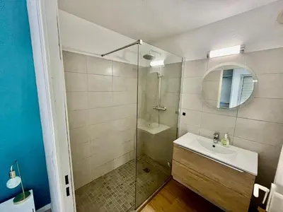 a bathroom with a shower and a sink and a mirror at Le riviera bay avec parking in Saint-Laurent-du-Var