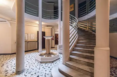 a spiral staircase in a building with columns at MY CASA - VERDI - Superb Studio Suite City Center in Nice
