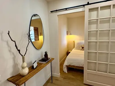 a bedroom with a mirror and a bed at Studio cosy - Vue mer - Terrasse - Parking in Saint-Laurent-du-Var