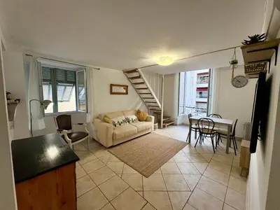 a living room with a couch and a table at Parenthèse Niçoise - Cœur de Nice in Nice