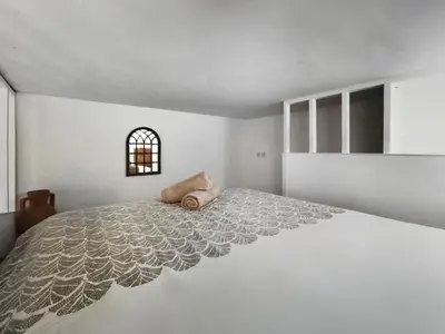 a white bedroom with a large bed in a room at Studio moderne et douillet au cœur de Nice in Nice