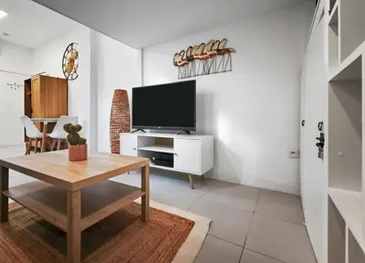 a living room with a tv and a table at Studio moderne et douillet au cœur de Nice in Nice