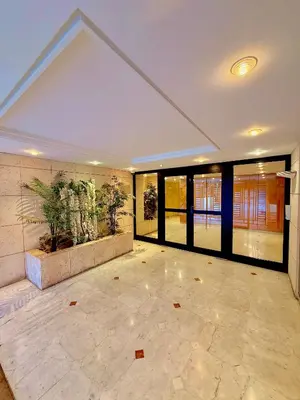 an empty lobby with a plant on the wall at Appartement moderne climatisé avec piscine, terrasse et parking - Proche Promenade des Anglais in Nice