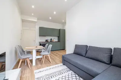 a living room with a couch and a table at Au cœur de Nice, Gare à pied et Climatisation in Nice