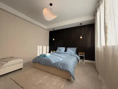 a bedroom with a bed with a black headboard at Oscar II in Nice