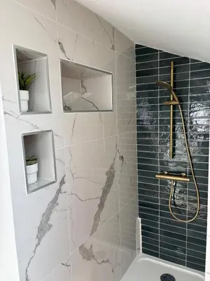 a bathroom with a shower with blue and white tiles at Cocon lumineux sous les toits de Nice in Nice