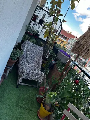 a balcony with a chair and a lot of plants at Port of Nice Terrace Apartment in Nice
