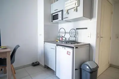 a small kitchen with a sink and a dishwasher at Bail mobilité - Beau studio proche tram Saint-Roch in Nice