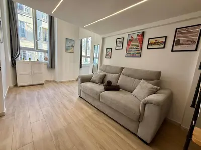 a living room with a couch and a staircase at Studio Rio - Jean Médecin - La Riviera LCD in Nice