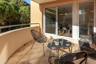 a balcony with two tables and chairs on a patio at Le Pin - Peaceful - Parking - Comfort - AC in Saint-Laurent-du-Var