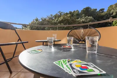 a table and chairs sitting on a patio at Le Pin - Peaceful - Parking - Comfort - AC in Saint-Laurent-du-Var