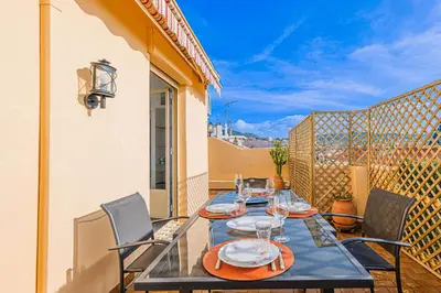 a dining table on the balcony of a house at Bail mobilité - Appartement 2 ch - Nice centre in Nice