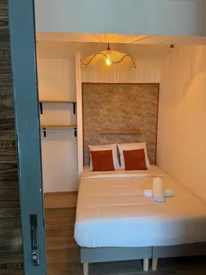 a bedroom with a large bed with a large headboard at Nid Azuréen – À deux pas de la plage, 6P in Saint-Laurent-du-Var