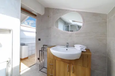 a bathroom with a sink and a mirror at Duplex à 2 min de la mer à pied in Nice