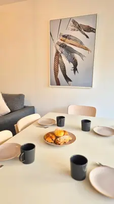a table with a plate of food on it at T3 neuf climatisé avec parking à Nice in Nice