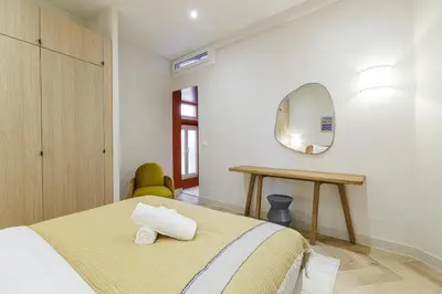 a bedroom with a bed and a mirror at 62 CARNOT LOT 5 - Appartement renove - climatise 2 chambres suites in Nice