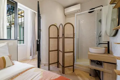 a bedroom with a bathroom with a shower and a sink at 62 CARNOT LOT 5 - Appartement renove - climatise 2 chambres suites in Nice