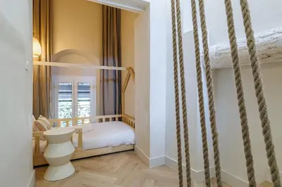 a small bedroom with a bed and a window at 62 CARNOT LOT 7 - Appartement Duplex Atypique- climatise - 2 chambres in Nice