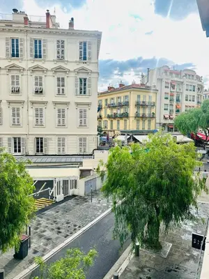 an empty street in a city with buildings at Appartement neuf d architecte Carré d Or in Nice