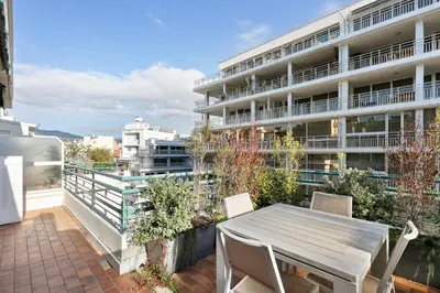 a balcony with a table and chairs and a building at Suite Lycka FSHH in Nice