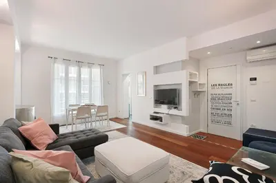 a living room with a couch and a tv at Suite Lycka FSHH in Nice