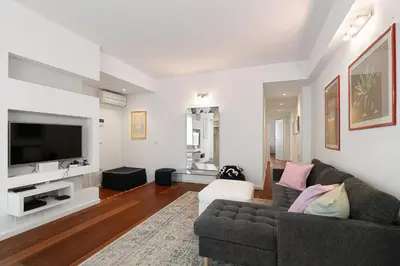a living room with a couch and a tv at Suite Lycka FSHH in Nice