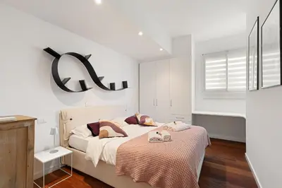 a bedroom with a bed with two towels on it at Suite Lycka FSHH in Nice