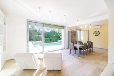 a kitchen and dining room with a table and chairs at VILLA MARIE -Pool - Garden-Close To Beach -Parking in Nice