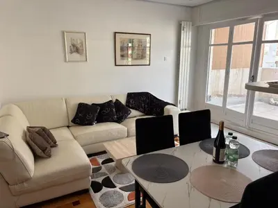 a living room with a couch and a table at Appartement T3 NICE Promenade des Anglais in Nice